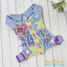 Decorative dog harness with floral and rainbow patterns on a wooden surface, branded 'Foo Foo Fido'.